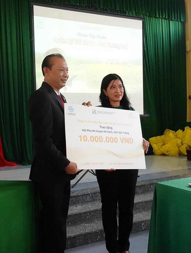 Ông Hà Văn Đức – Giám đốc kinh doanh Miền – Miền Mekong 3 của công ty Phú Hưng Life trao bảng tài trợ cho Hội Liên Hiệp Phụ Nữ huyện Kế Sách