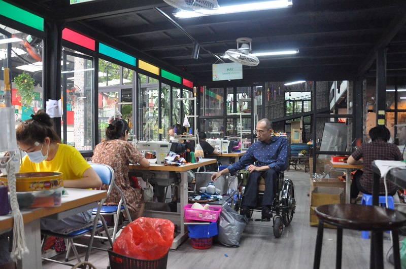 The chairman in a wheelchair helps people with disabilities 