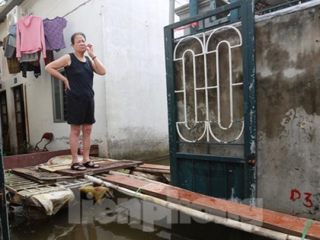 Một tuần sau mưa, người Hà Nội vẫn phải bắc 'cầu khỉ' vượt nước ngập