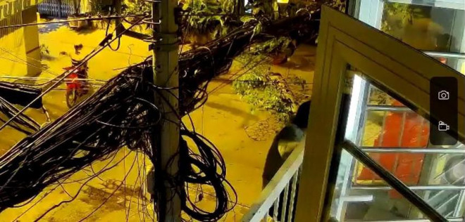 Trong khi đó, đồng bọn bên dưới mặc đồ xe ôm công nghệ, đánh lạc hướng người qua đường. Ảnh chụp từ clip