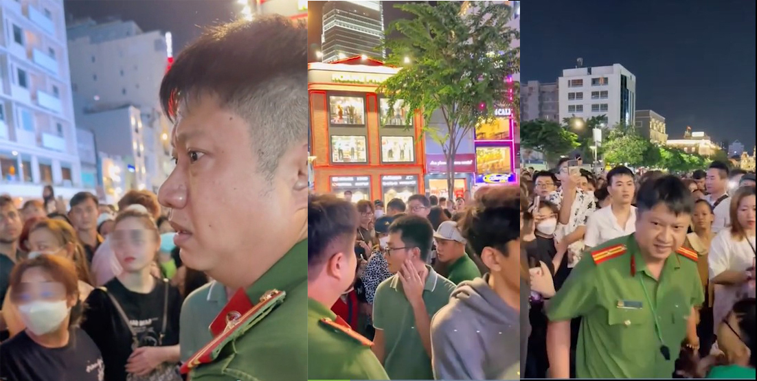 Anh công an bị đám đông cản trở ở phố đi bộ Nguyễn Huệ. Ảnh cắt từ clip