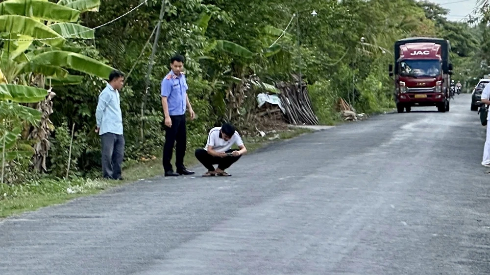 Điều tra viên Cục Điều tra VKSND Tối cao tiếp cận, ghi nhận hiện trường vụ tai nạn giao thông ở Vĩnh Long cùng với các nhân chứng