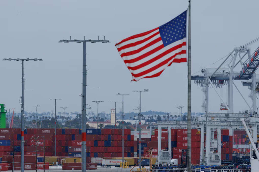 Cờ Mỹ tung bay gần các container Trung Quốc tại cảng Los Angeles.. Ảnh: Reuters