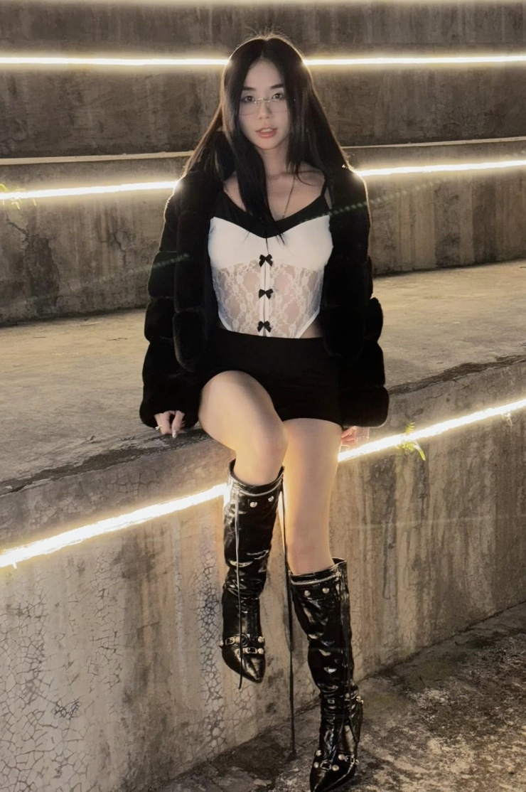 Trong chuyến du lịch năm 2024, cô mặc áo đắp ren xuyên thấu phối boots da.