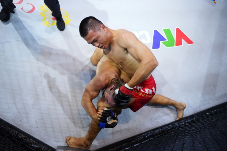 Trước khi "làm khổ" Zakhar bằng đòn gối, cùi chỏ, Công Minh (quần đỏ) đã chống trả các chiêu đấu&nbsp;vật và chịu đòn tốt