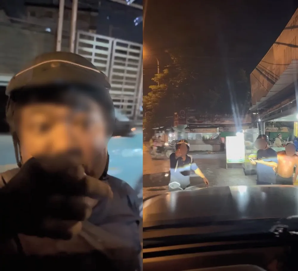 Hai người đàn ông chặn xe ô tô trên đường. Ảnh cắt từ clip