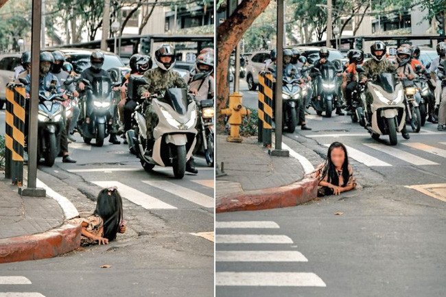 Người phụ nữ chui ra từ cống giữa ngã tư đông đúc gây xôn xao. Ảnh: NST