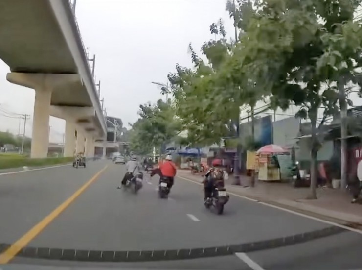 Và cú đạp sau đó đã khiến người và xe té ngã xuống đường. Ảnh: Cắt từ clip.