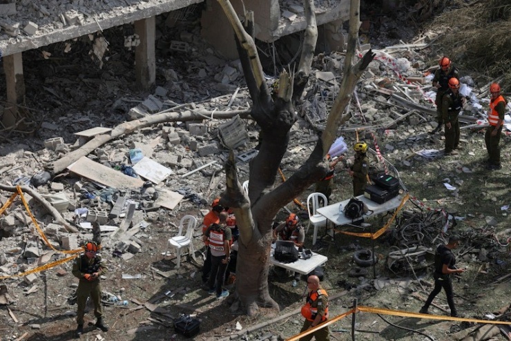 Khu vực cứu hộ được dựng lên ngay tại khu vực bị Iran không kích ở Tel Aviv. Ảnh: Reuters
