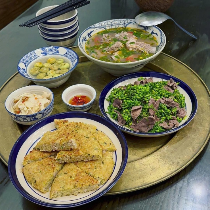Một mâm cơm nhẹ nhàng mà chất lượng: Canh sườn chua dịu, bông thiên lý xào thịt bò, chả chiên vàng thơm, kèm chút cà pháo và dưa góp cho đỡ ngấy. Thế là đủ để bữa tối thêm ấm lòng, đúng chuẩn món ăn ngon mỗi ngày.