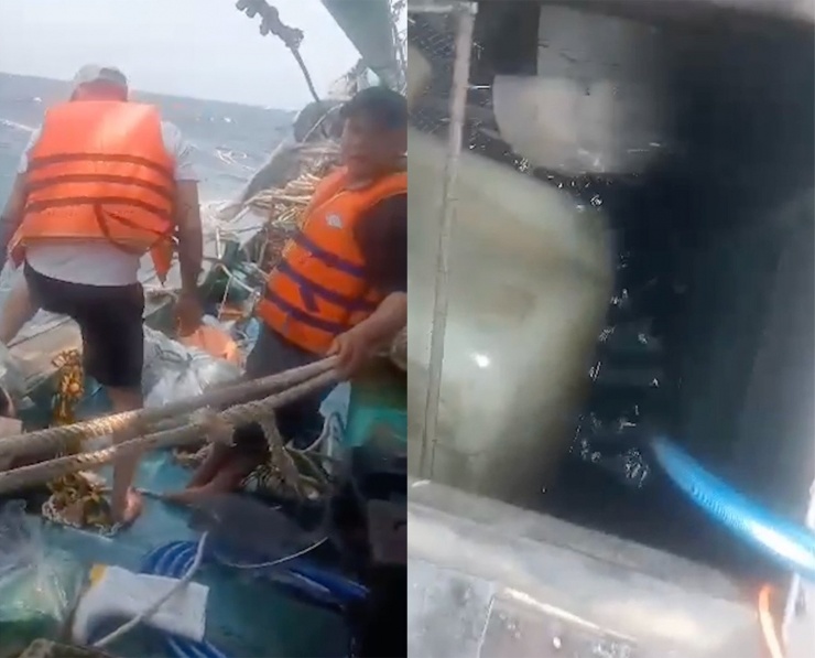 Khoang tàu ngập nước, các thuyền viên mặc áo phao chuẩn bị nhảy xuống biển thoát thân. Ảnh cắt từ clip