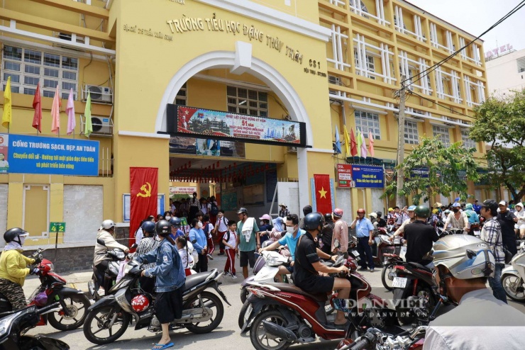 Phụ huynh đến đón con về vào buổi trưa tại Trường Tiểu học Đặng Thuỳ Trâm. Ảnh: N.M