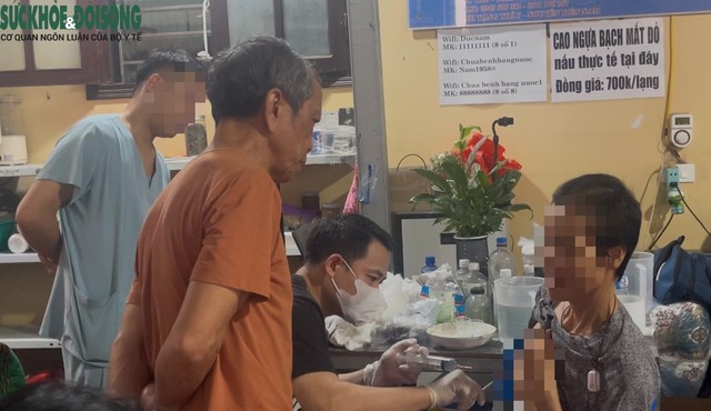 Ông Nguyễn Tiến Nam (áo nâu) đứng cạnh theo dõi ông Tuân can thiệp vết mổ ở ngực cho nữ bệnh nhân.
