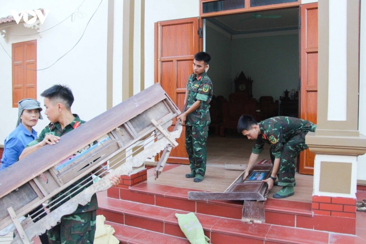 Khắc phục nắng nóng, các cán bộ, chiến sĩ nỗ lực giúp người dân vận chuyển đồ dùng đến nơi tạm cư.