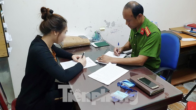 Chị Trần Thị T.A. trình đơn tố cáo tại Công an thành phố Vinh.