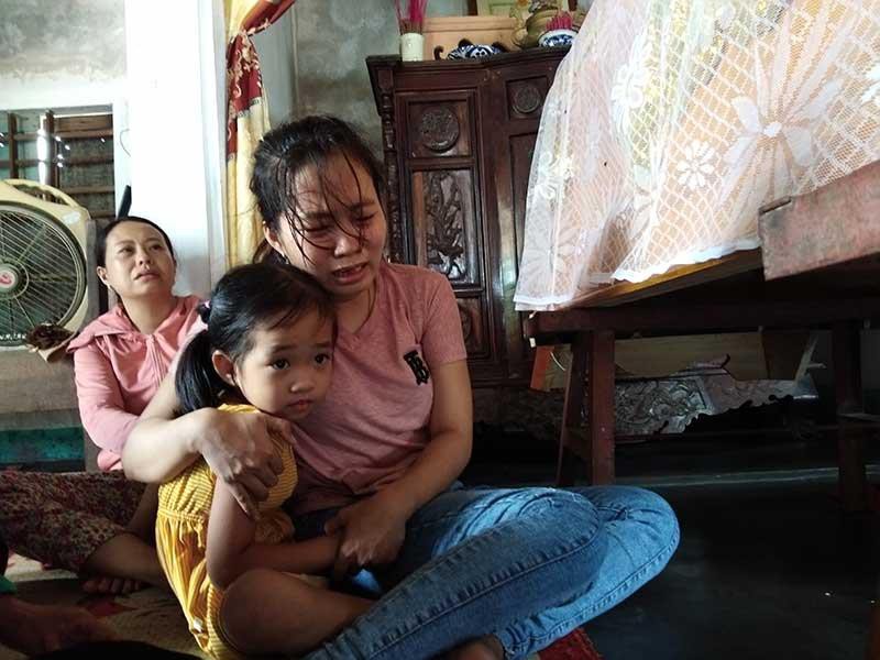 Vợ và con gái đau thương bên quan tài anh Khải. Ảnh: NGUYỄN DO