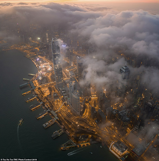 11. Tsz Ho Tse ở Hồng Kông đã chụp hình ảnh này tại cảng Victoria nổi tiếng thế giới  dưới những đám mây vào sáng sớm. Nó đã mang lại cho anh một giải ấn tượng trong hạng mục về thành phố và thể loại tự nhiên.
