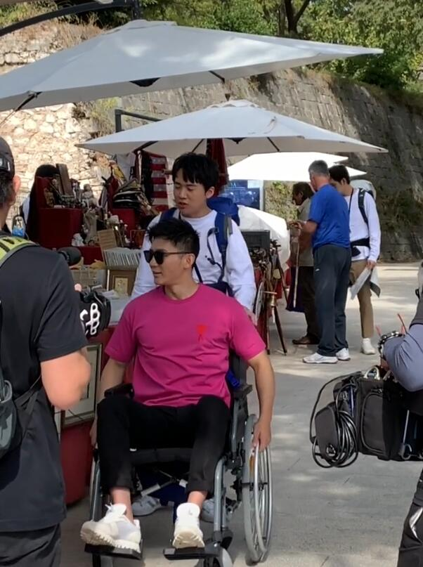 Nam diễn viên Lý Thần ngồi xe lăn, phải nhờ người hỗ trợ di chuyển.