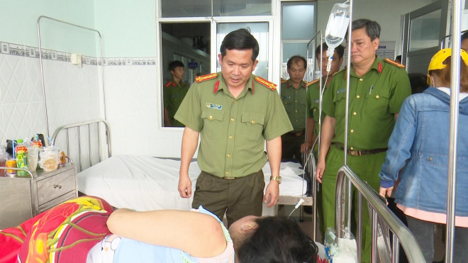 Đại tá Đinh Văn Nơi thăm hỏi và trao tiền hỗ trợ cho các nạn nhân trong vụ nghi vấn gã đàn ông đốt nhà người tình. Ảnh: Nguyễn Đệ