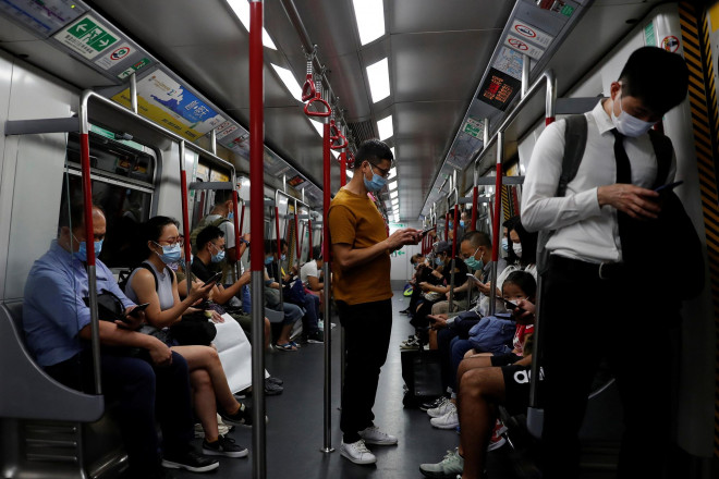 Hành khách trên tàu điện ngầm ở Hồng Kông hôm 15-7, một ngày sau khi Mỹ rút quy chế đặc biệt đối với đặc khu này Ảnh: REUTERS