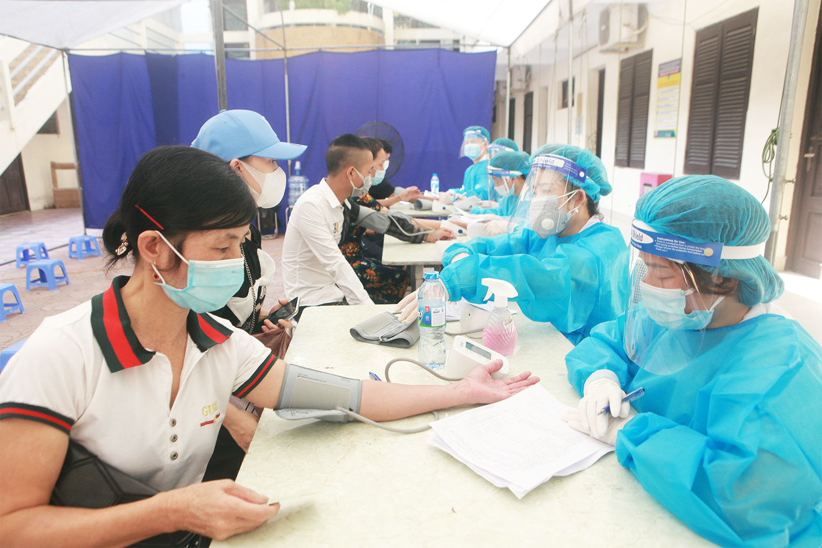 Người dân được nhân viên y tế tư vấn sức khỏe, kiểm tra huyết áp và thân nhiệt trước khi tiêm. Những người cao tuổi có chỉ số huyết áp cao bất thường được hướng dẫn nghỉ ngơi, hít thở đều trước khi tiêm.