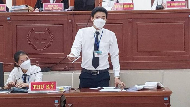 Thư ký công bố chiếc kéo, vật chứng trong vụ án tại phiên tòa sơ thẩm.