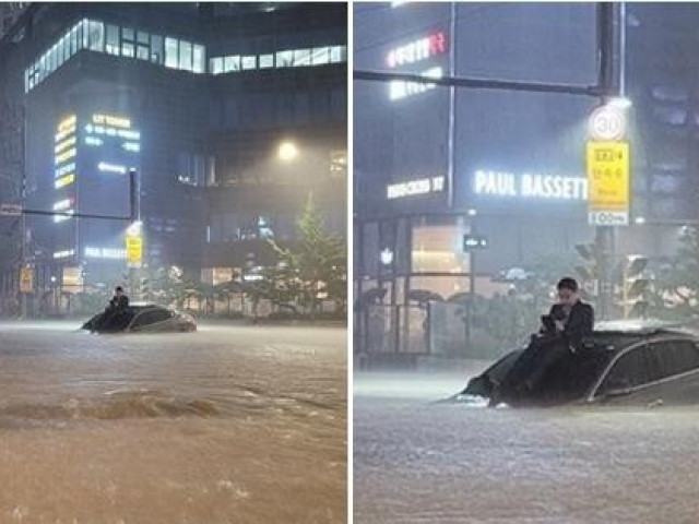 Bạn trẻ - Cuộc sống - Anh chàng “chill” trên mui ô tô giữa mưa to ngập đường ở Hàn Quốc, dân mạng vội tìm "in tư"