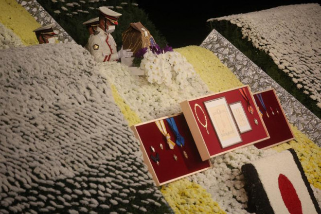 Tro cốt nhà cố lãnh đạo Nhật Bản được
đặt lên lễ đài trong sự xúc động của tất cả những người tham
gia.