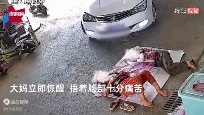 Hai người phụ nữ nằm ngủ trên đường, không biết nguy hiểm sắp đến.