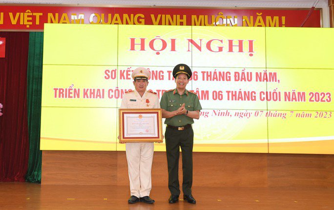 Thiếu tướng Đinh Văn Nơi , Giám đốc Công an tỉnh Quảng Ninh (bên trái), đón nhận Huân chương Chiến công hạng nhất. Ảnh: Công an tỉnh Quảng Ninh