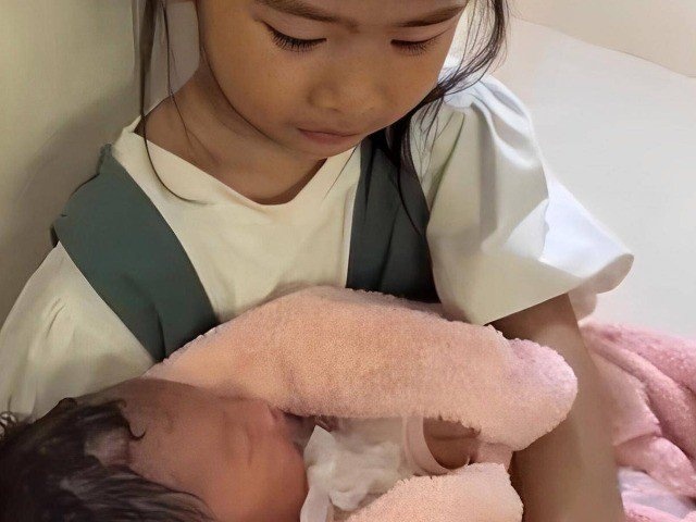 Bạn trẻ - Cuộc sống - Bé gái 6 tuổi một mình ngồi ôm bé sơ sinh ở hành lang bệnh viện, câu chuyện phía sau khiến ai cũng nghẹn ngào