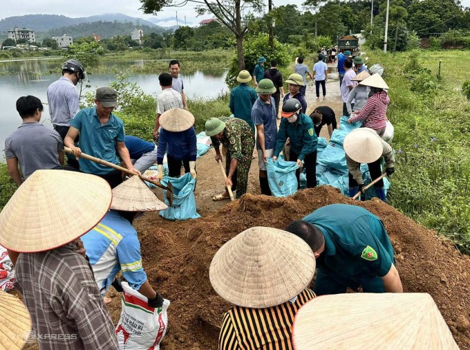 Người dân đắp đê ở huyện Quốc Oai, sáng 28/7. Ảnh: Gia Chính