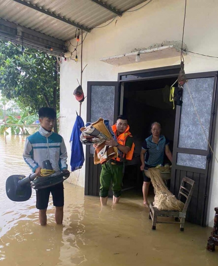 Lực lượng chức năng hỗ trợ người già sơ tán lên chỗ an toàn. Ảnh: Công an Ninh Bình