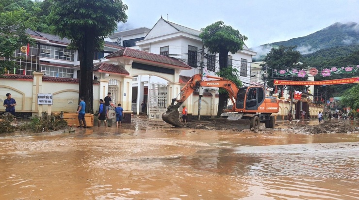 Tại khu vực trung tâm trụ sở hành chính xã Mường Xén, một lượng bùn đất khổng lồ bủa vây, chính quyền xã phải huy động nhiều máy múc đến cào, dọn dẹp.