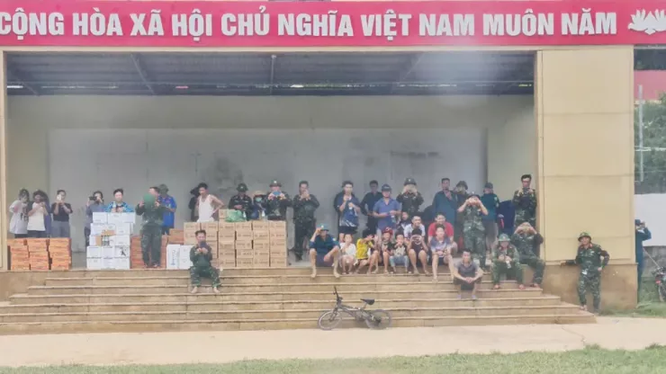Bà con nhân dân vùng lũ chờ trực thăng hạ cánh mang theo hàng hóa, lương thực, nước uống.