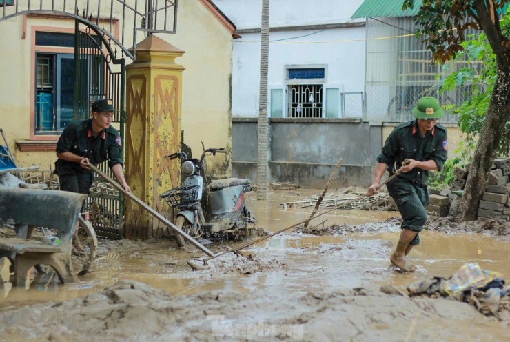 Cảnh sát cơ động lội bùn, giúp dân dọn dẹp sau lũ - 3