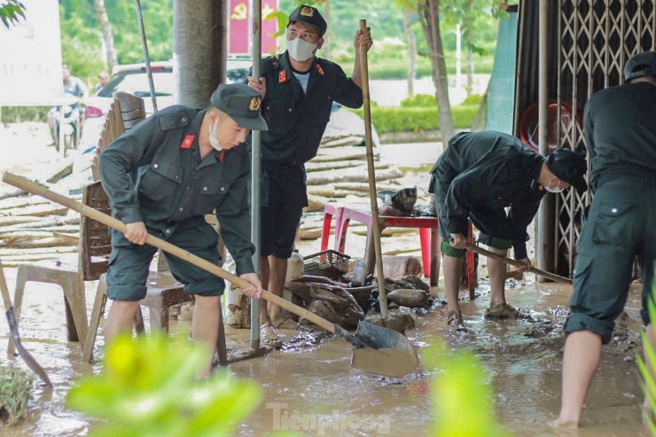 Cảnh sát cơ động lội bùn, giúp dân dọn dẹp sau lũ - 9