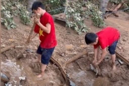 Cháu bé lớp 5 bới bùn đất tìm quần áo cho bà mặc sau cơn lũ ở Nghệ An