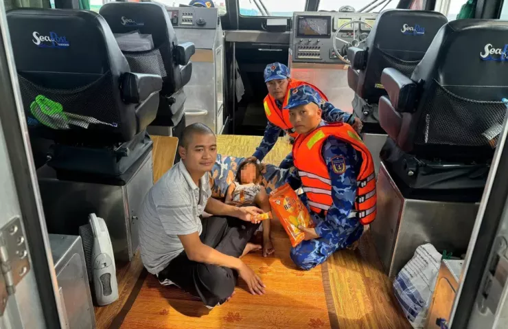 Cảnh sát biển đưa hai bố con anh Tùng vào bờ.