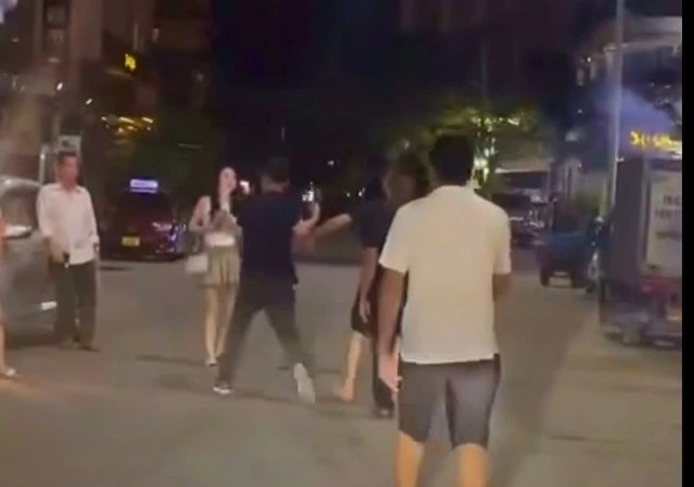 Hình ảnh người phụ nữ bị nhóm người đàn ông hành hung. (Ảnh cắt từ clip)