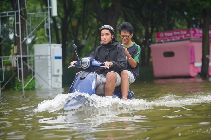 Đường và hồ &#39;hòa làm một&#39; sau mưa lớn, người dân lấy cọc làm mốc để lội về nhà - 9