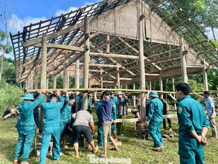 Lực lượng chức năng khẩn trương hỗ trợ gia đình di dời nhà ra khỏi nơi nguy hiểm.