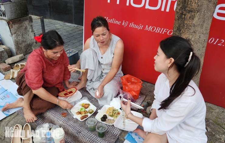 Gia đình chị Thanh, thuê khách sạn VIP nhưng ra vỉa hè ăn uống trải nilon để giữ chỗ đẹp xem tổng duyệt diễu binh. Ảnh: Thanh Tuấn