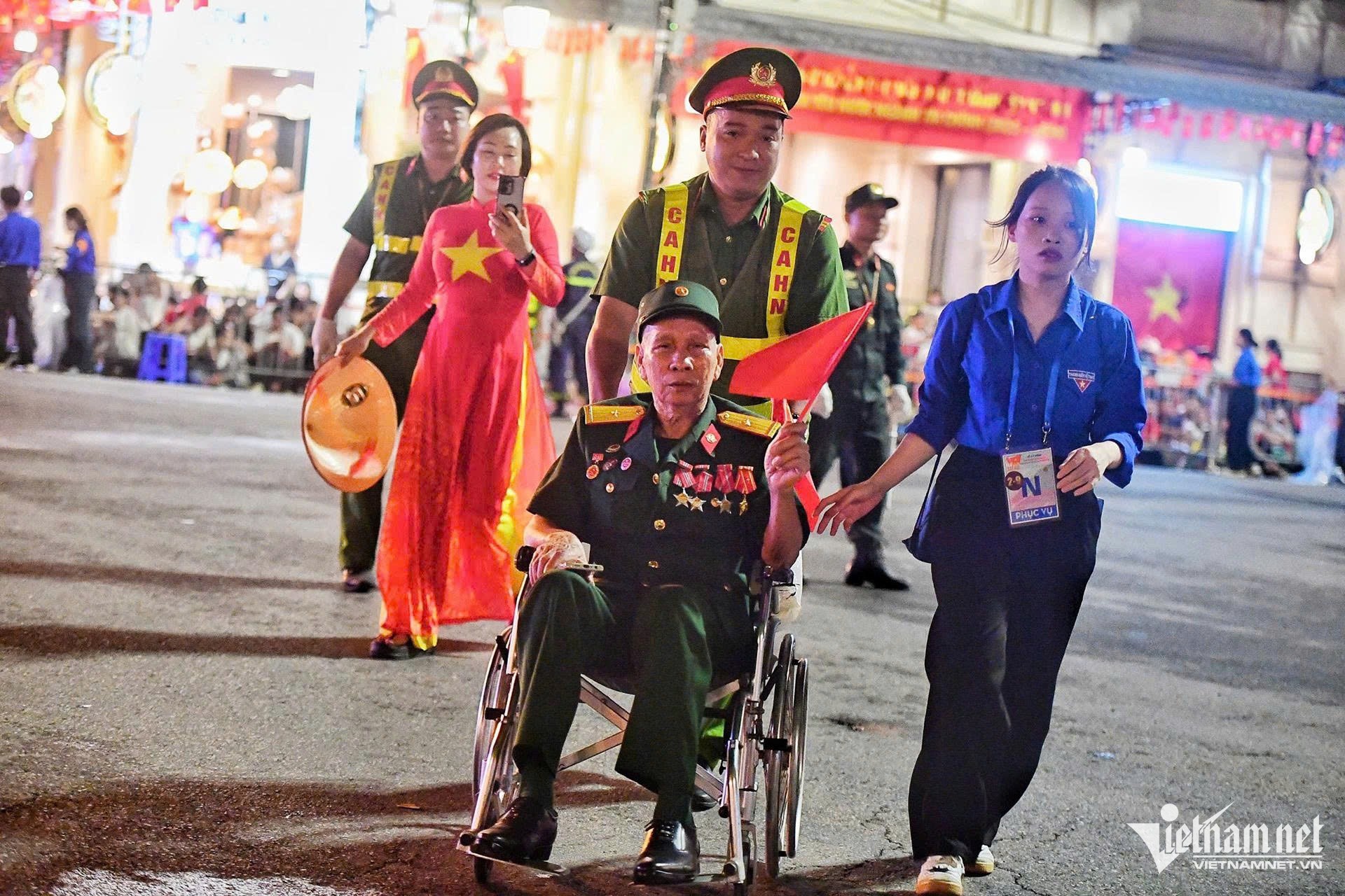 Ông Lê Văn Thịnh (82 tuổi, quê Lào Cai) được cán bộ hỗ trợ vào vị trí ưu tiên. Ảnh: Nguyễn Huế