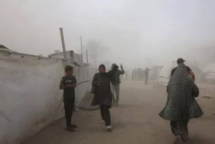 Người dân Palestine bỏ chạy khi khói bao phủ khu vực gần Mushtaha Tower (TP Gaza) ngày 5-9. Ảnh: AFP