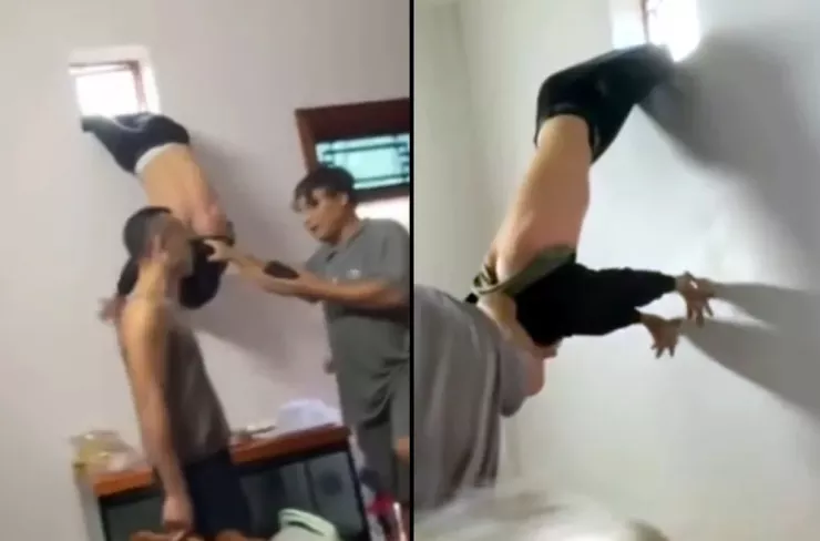 Hình ảnh người đàn ông Mắc kẹt khi chui qua lỗ thông gió bị chủ nhà giữ lại báo công an. Ảnh: Cắt ra từ clip
