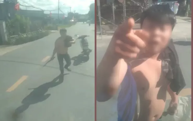 Người đàn ông biểu hiện say xỉn tay cầm rựa chặn xe tải ở xã Củ Chi. Ảnh chụp từ clip