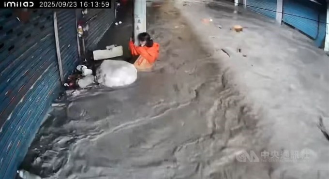 Một người phụ nữ Hoa Liên sống sót giữa dòng nước dữ nhờ bám vào cột. Ảnh: Focus Taiwan