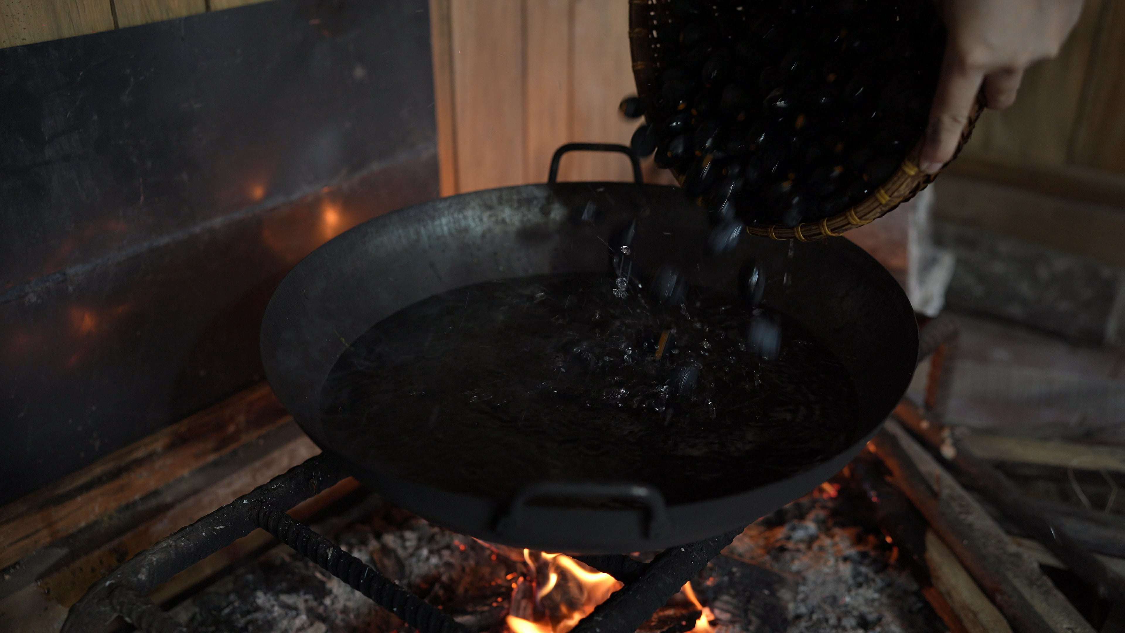  Trám đen cho vào nồi ngập nước rồi đun dưới lửa. Khi nào sờ tay vào thấy nóng già, rát tay, khoảng 70-80 độ C thì tắt bếp và ngâm thêm khoảng 20 phút. (Ảnh: Lê Thị Thuỷ)