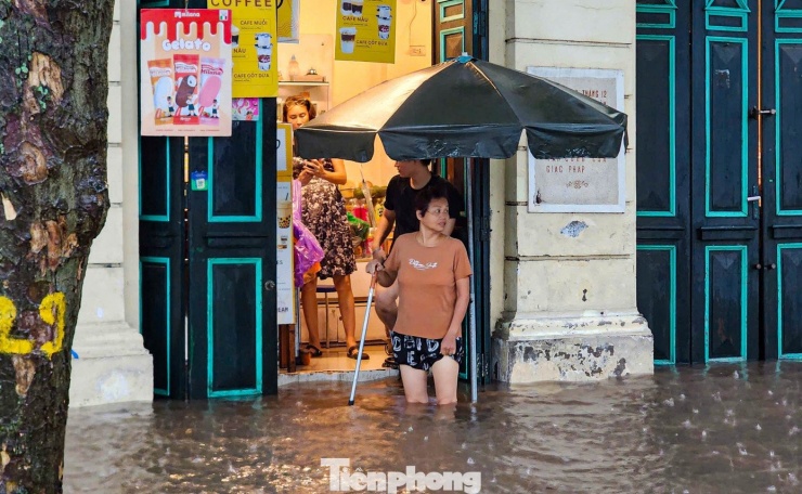 Người dân phố Đinh Tiên Hoàng vất vả dọn dẹp nhà cửa.